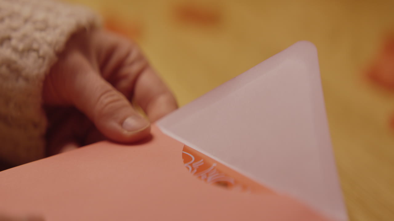 Hands Opening a Pink Envelope/Gift Box