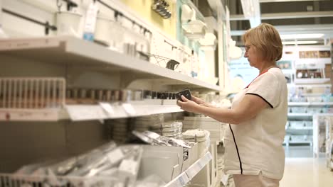 woman shopping for dishes in a home goods store