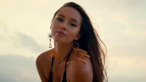beautiful woman in bikini at sunset