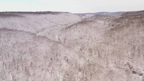 aerial of snow covered valley in new england after winter storm