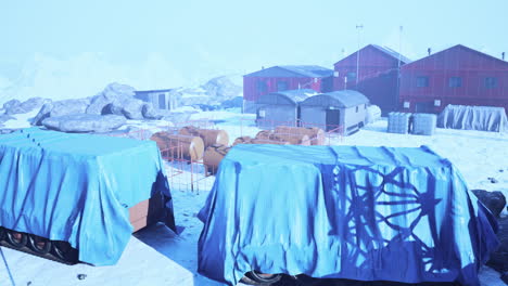 snow around building of polar station in antarctica