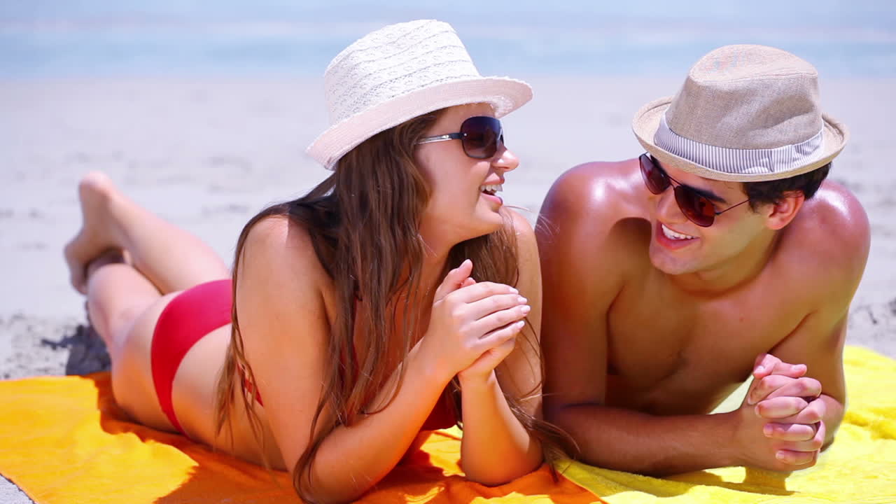 Couple lying on towels