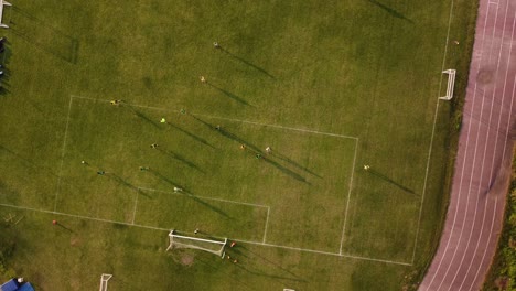 aerial top down view of women's football team play in a gardeng