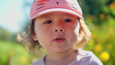 little girl face close-up in a park