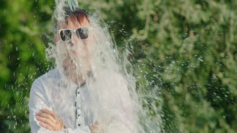 man gets water poured on his head