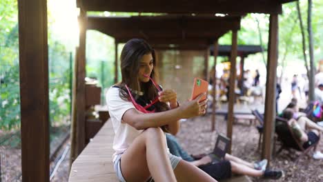 woman taking a selfie outdoors in a park