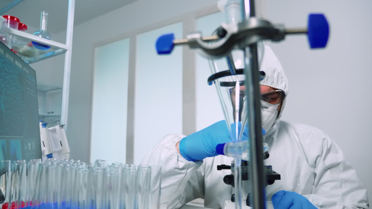 Researcher in ppe suit conducting DNA experiments