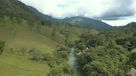 Drone-aerial-view-flying-over-valley-and-Cahabon-river-in-Guatemala-during-a-beautiful-sunny-day