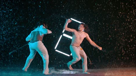 men train capoeira indoor wet studio, caucasian and black men practicing fight