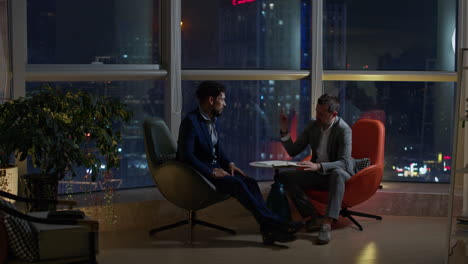 business meeting at night with city view