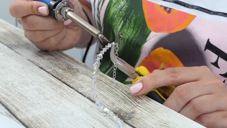 Close-View-of-Female-hands-repairing-a-crystal-bracelet