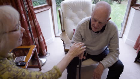 an elderly couple talking together indoors