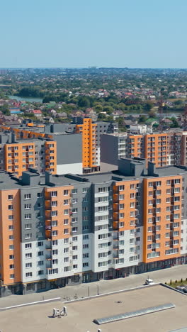 exterior of the multistorey apartment. aerial view of city residential area with high apartment buildings. vertical video