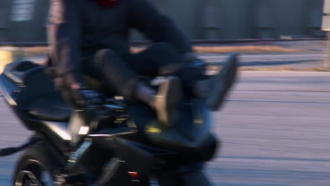 a rider performs stunts on a motorcycle in a parking lot 1