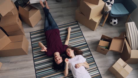 couple relaxing on floor during move