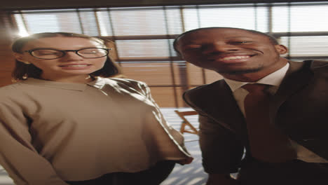 diverse colleagues talking on video call in office