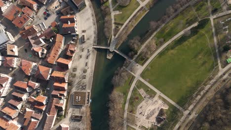 aerial view of a town with a river and park