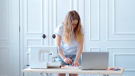 woman learning sewing design online