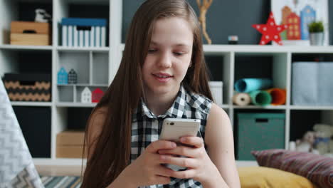 girl using smartphone in a kids room