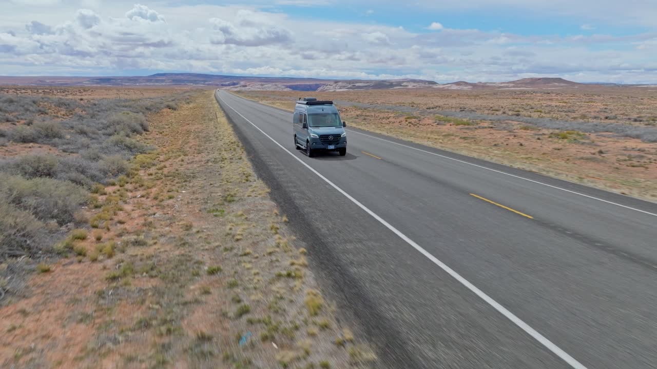 Mercedes Sprinter Van Driving On The Asphalt Road Near Grand Canyon National Park In Arizona, United States