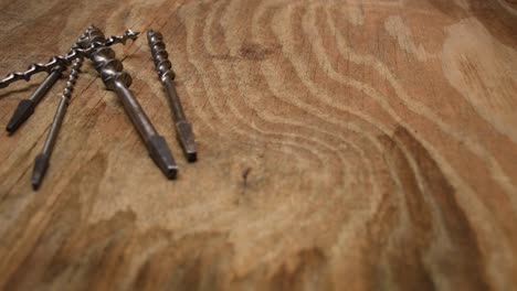 Old-drillbits-on-wooden-table-in-woodshop