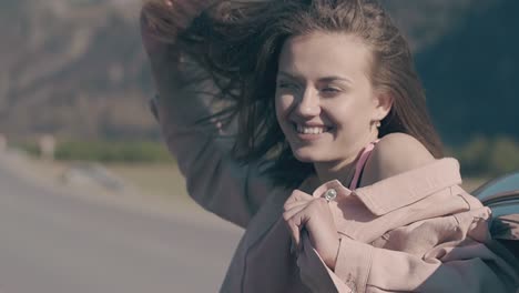 pretty woman smiles and enjoys car trip on sunny day