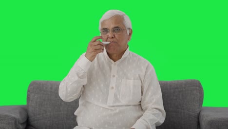 Sick-Indian-old-checking-fever-using-thermometer-Green-screen