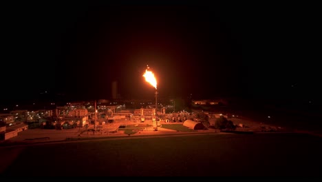 the surrounding area is illuminated by the radiant light emitted from gas flaring - aerial panning