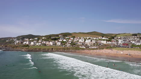 low aerial orbit of a sandy golden beach on a perfect summer’s day