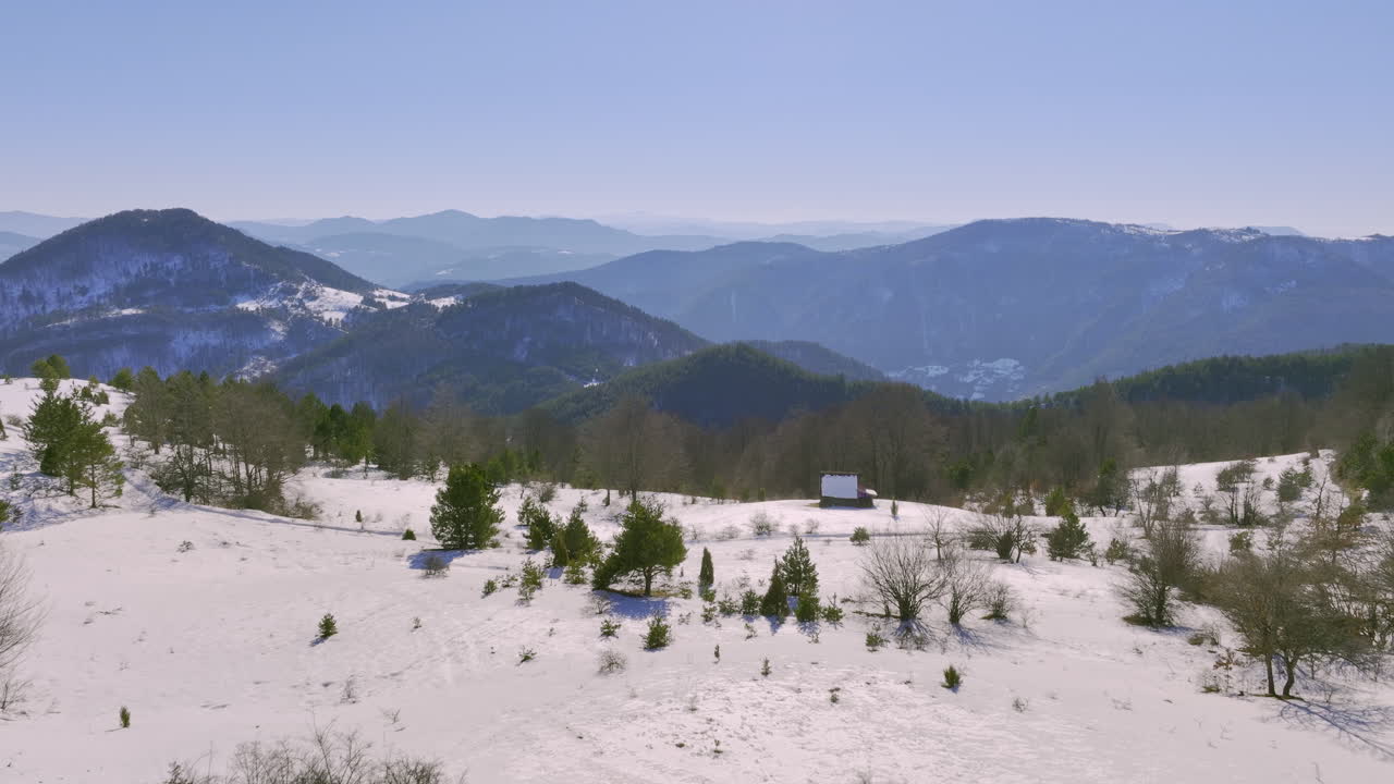 Snowy wooden house nestled in a serene mountain landscape