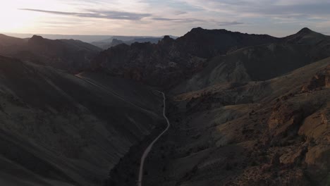 drone wide slow move over leslie gulch oregon of entire canyon and road with soft light at dusk