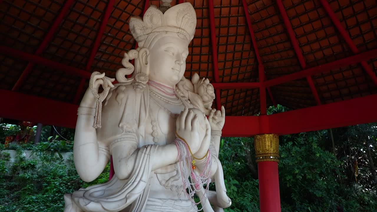Serene White Statue in a Red Temple