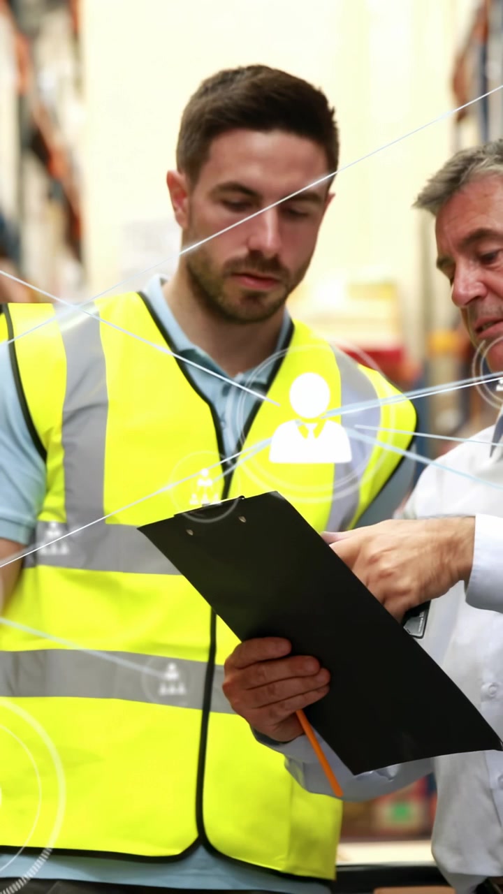 Vertical video: Warehouse worker reading clipboard as lead lifting scanner UI icons updating stock