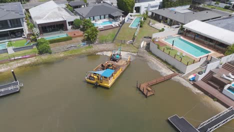 canal dredging operation near luxury homes