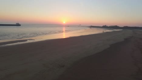 Aerial:-The-boulevard,-beach-and-city-of-Vlissingen-during-sunset