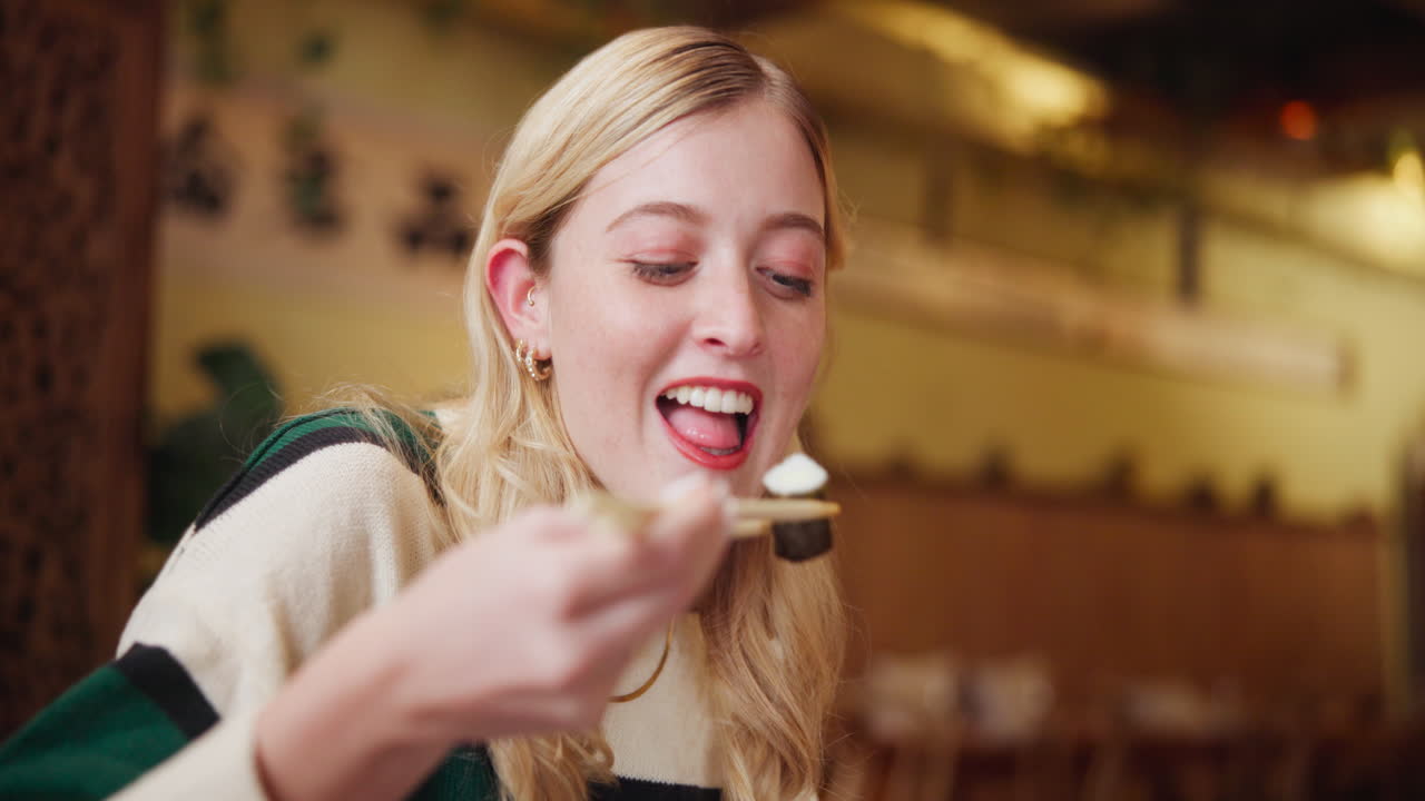 Woman eating with chopsticks
