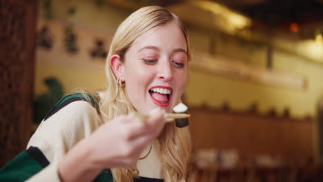 woman eating with chopsticks