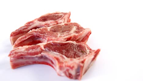 three beef chops on white background