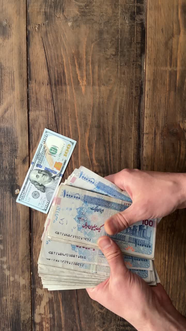Money Banknote Bunch Bundle 100 Dollar VS Rial Toman Iran Currency Versus American USA Wooden Background Bank Billion Bills Business Cash Debt Dollars Economy Finance Loan Million Note Profit Wealth