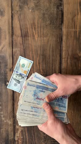 money banknote bunch bundle 100 dollar vs rial toman iran currency versus american usa wooden background bank billion bills business cash debt dollars economy finance loan million note profit wealth
