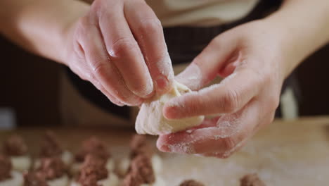 a professional baker makes dumplings with meat filling. delicious traditional ukrainian cuisine