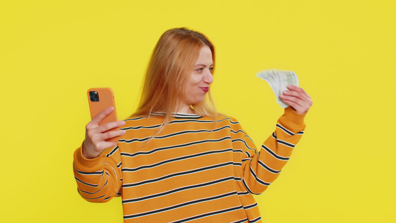 Happy woman use smartphone rejoicing game win receiving money dollar cash celebrating success
