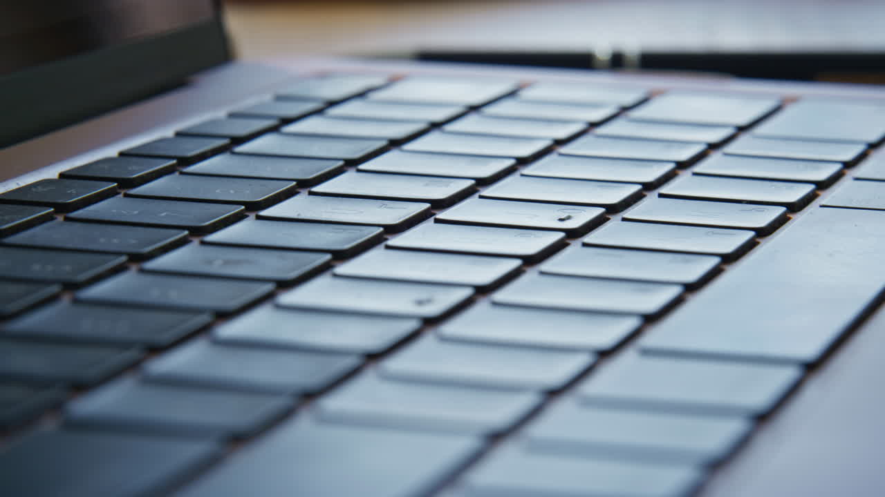 Closeup laptop keyboard buttons indoors. Macro view modern key device in detail