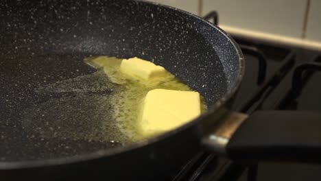 cs butter melting into a pan creating frying bubbles of fat, health concept