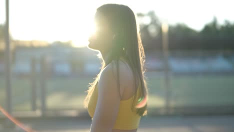 female athlete running on outdoor track in sportswear