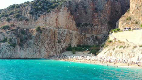 Aerial-drone-flying-low-near-the-turquoise-blue-Mediterranean-Sea