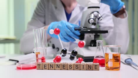 scientist in a lab with molecular model and chemistry equipment