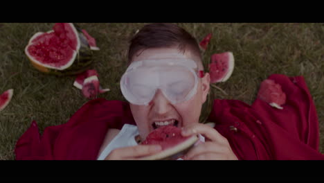 person eating watermelon with safety glasses
