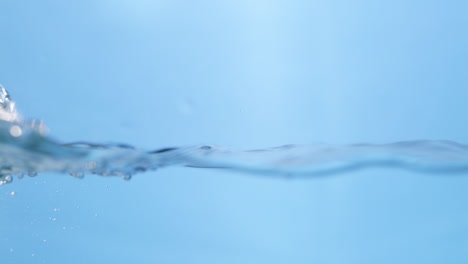 a single water drop falls into a smooth pool, creating perfect ripples. the motion highlights the purity and simplicity of clean water.