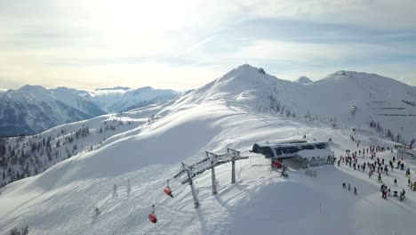 4k drone shot of a ski lift on a perfect snowy mountain with people wintersport flachau, austria